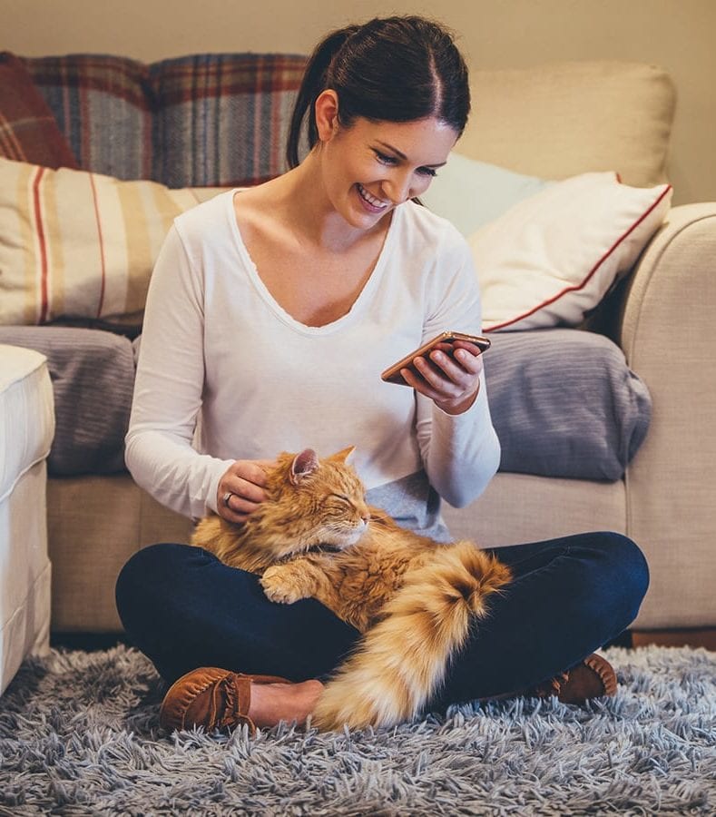 woman-on-phone-with-orange-cat